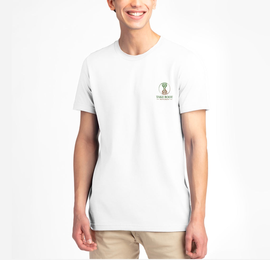 Person wearing white Christian T-shirt with ‘Take Root Movement’ text and green-to-brown rooted tree logo on the front.