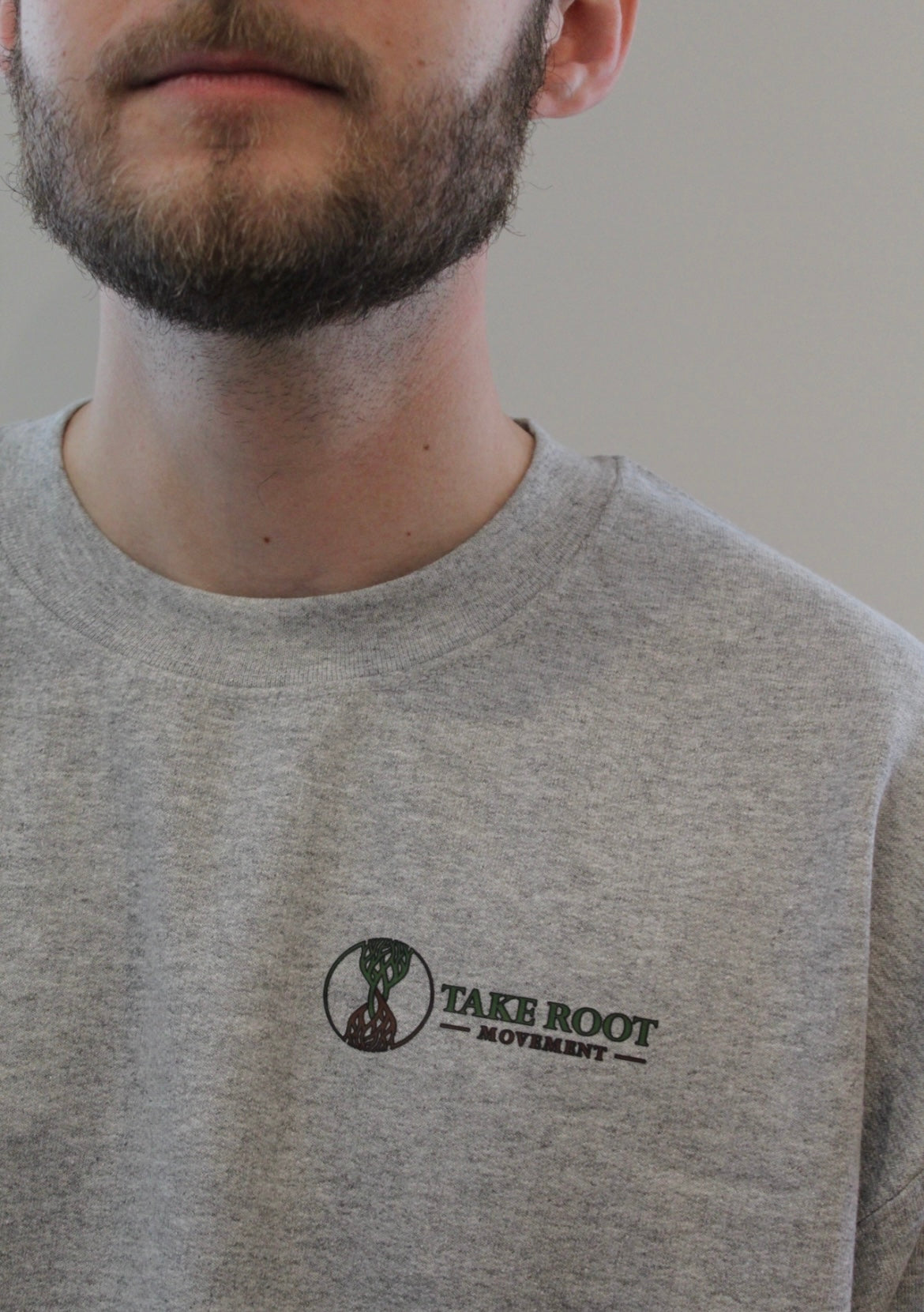 Grey Take Root Movement sweatshirt with logo on right hand side