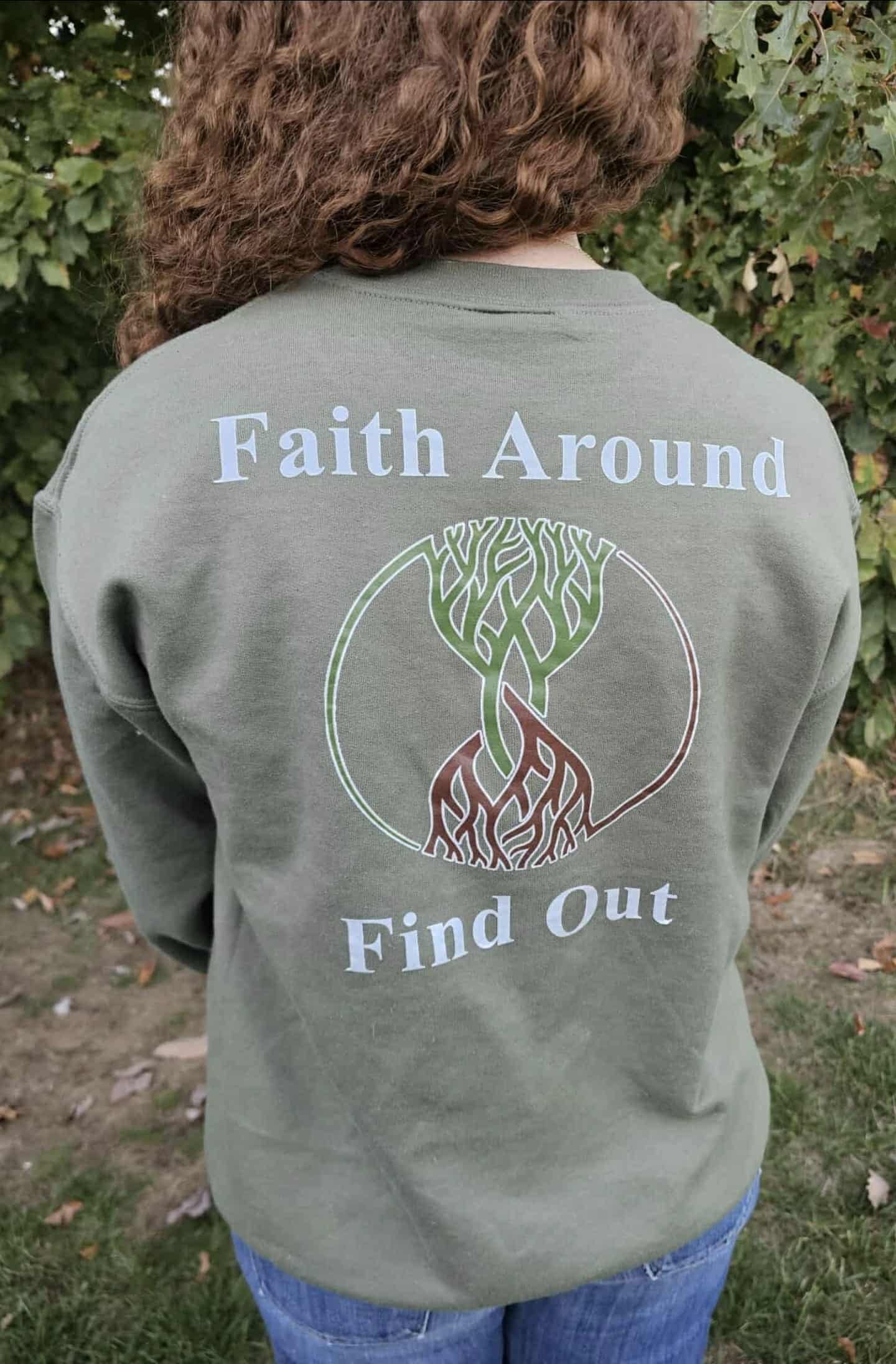 Olive green Take Root Movement sweatshirt with ‘Faith Around Find Out’ text and intertwined tree-and-roots logo on the back.
