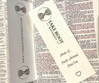 Two Take Root Movement Christian bookmarks placed inside an open Bible, featuring the intertwined tree and roots logo, ‘Faith Around Find Out’ message, and website on white cardstock.
