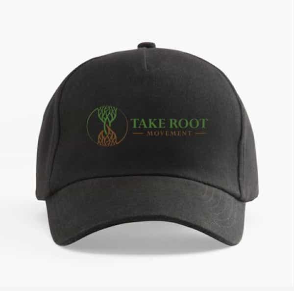 Black curved brim baseball cap featuring the Take Root Movement Christian logo with intertwined green tree and brown roots on the front.