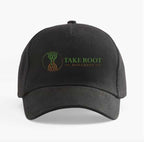Black curved brim baseball cap featuring the Take Root Movement Christian logo with intertwined green tree and brown roots on the front.